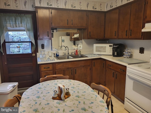 kitchen featuring white appliances and sink