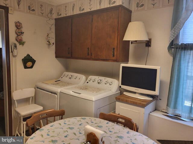 laundry area with cabinets and separate washer and dryer