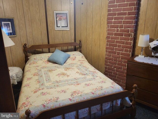 bedroom with wooden walls