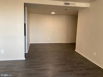 spare room featuring dark hardwood / wood-style flooring