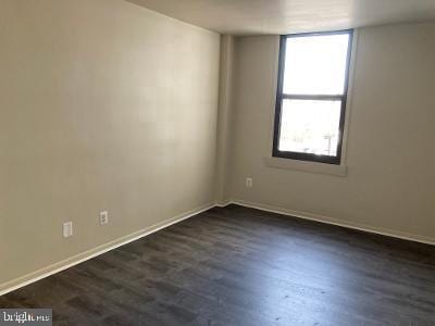 empty room with dark hardwood / wood-style floors