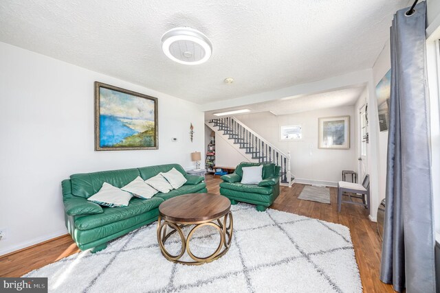 living room featuring a textured ceiling and hardwood / wood-style floors