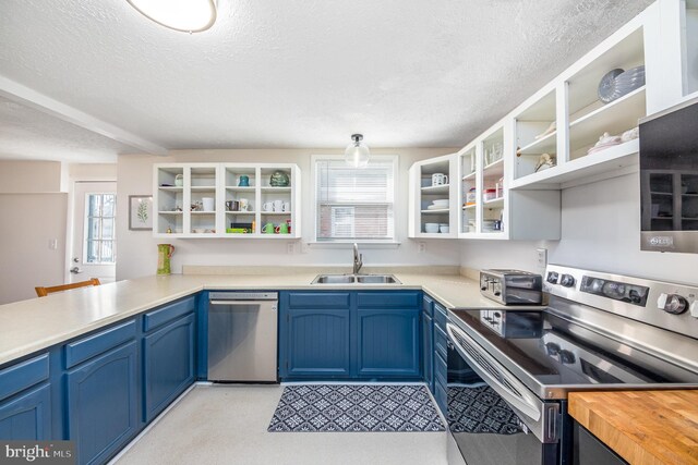 kitchen with appliances with stainless steel finishes, a textured ceiling, and sink