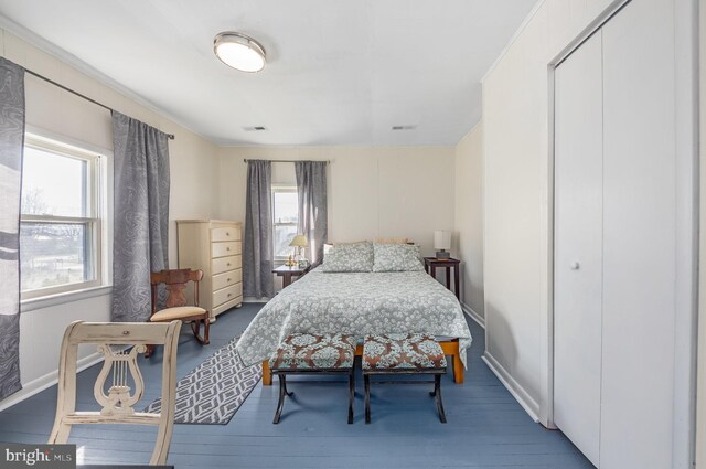 bedroom with a closet and hardwood / wood-style flooring