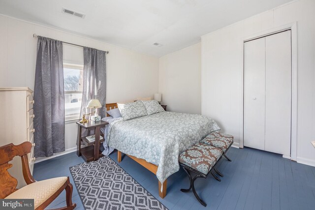 bedroom featuring wood-type flooring and a closet