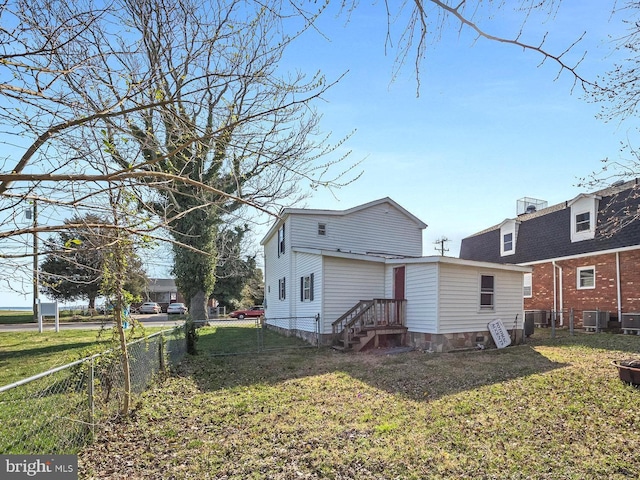 back of house with a yard and central AC unit