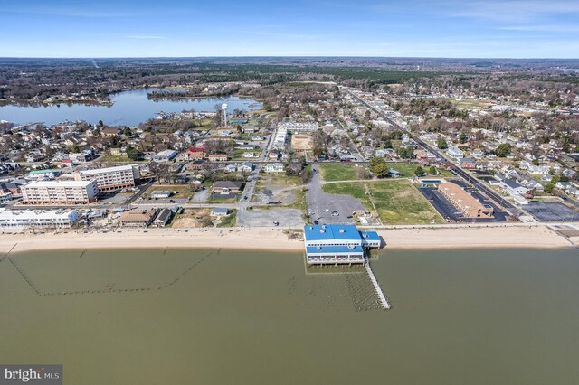 drone / aerial view featuring a water view and a beach view