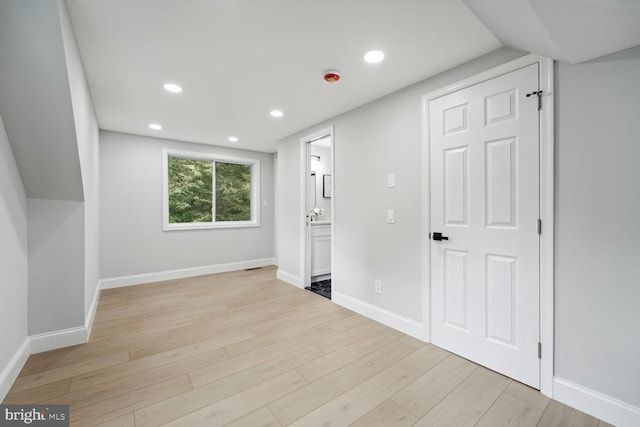 additional living space featuring light wood-type flooring