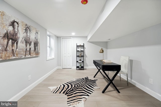 office with light hardwood / wood-style flooring