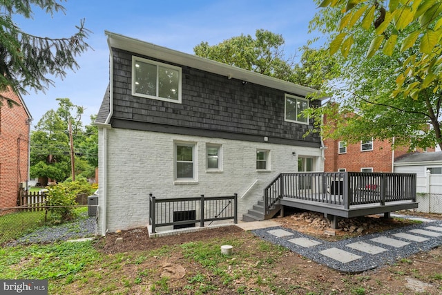 back of property with a wooden deck