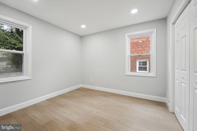 unfurnished bedroom with light hardwood / wood-style floors and a closet