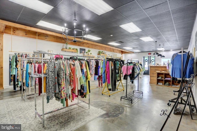 interior space with concrete floors and a drop ceiling