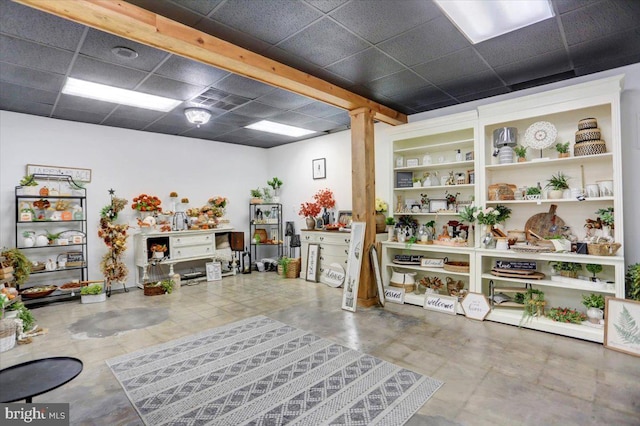 misc room featuring built in shelves and a paneled ceiling