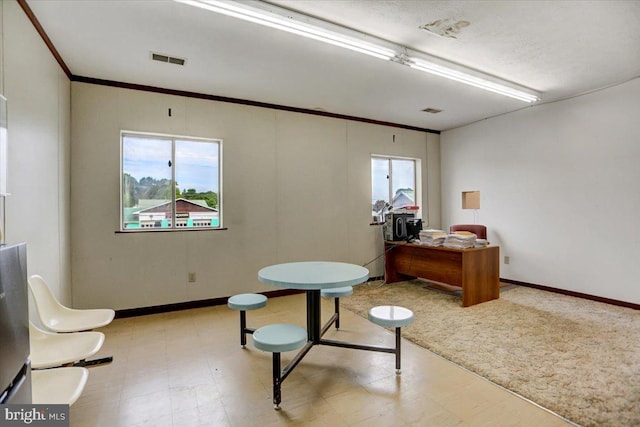 living area featuring crown molding