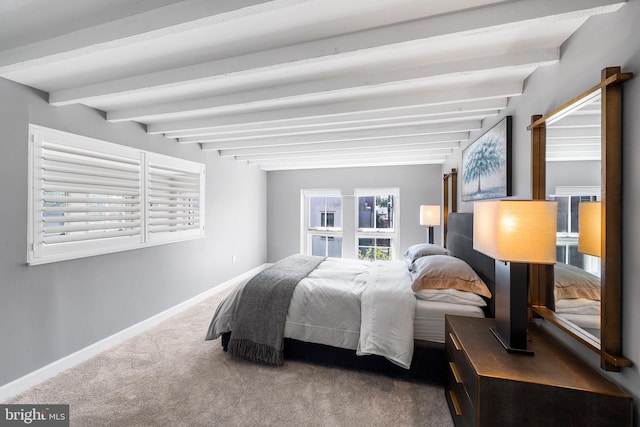 bedroom with carpet flooring and beam ceiling