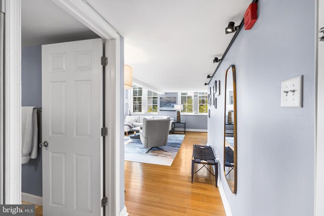 corridor with light hardwood / wood-style flooring