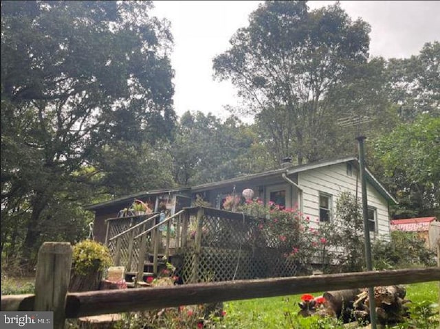 view of property exterior featuring a deck