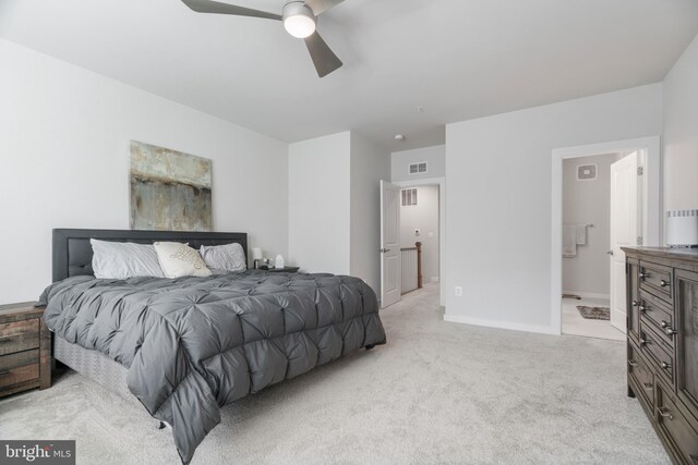 carpeted bedroom featuring ceiling fan and ensuite bath