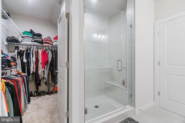 bathroom with walk in shower and tile patterned flooring