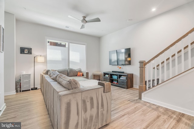 living room with ceiling fan and light hardwood / wood-style floors