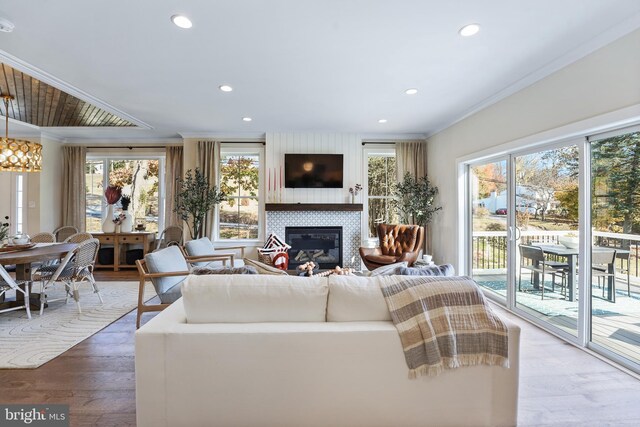 hall featuring crown molding, hardwood / wood-style floors, and a chandelier