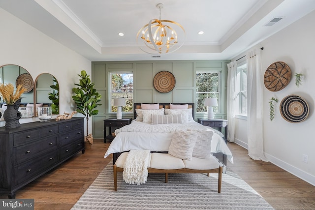 bedroom featuring crown molding, hardwood / wood-style flooring, a closet, and ceiling fan