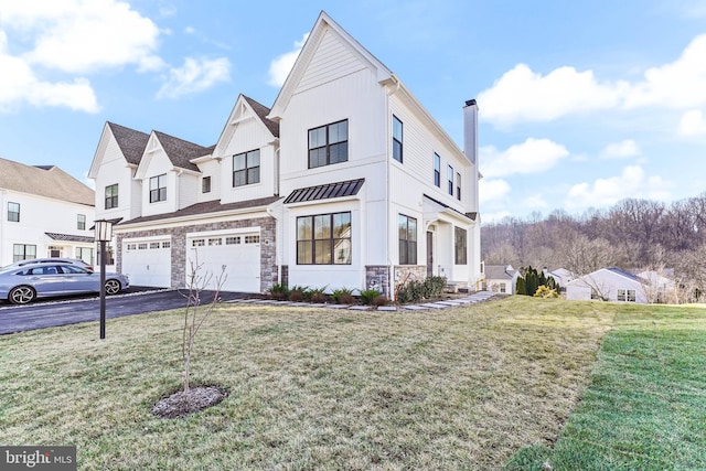 view of front of property featuring a front yard and a garage