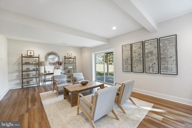 interior space with light hardwood / wood-style flooring and beam ceiling