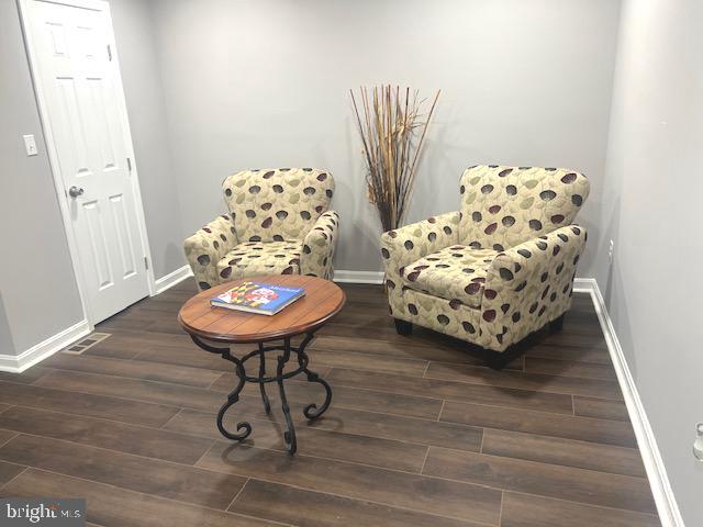 living area with dark hardwood / wood-style flooring