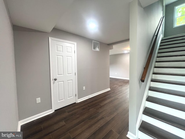 basement with dark hardwood / wood-style floors