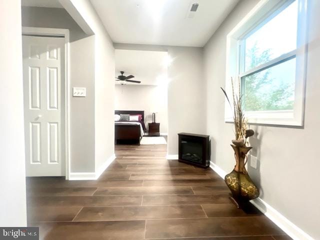 hallway with dark hardwood / wood-style floors