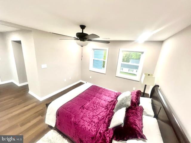 bedroom with ceiling fan and wood-type flooring