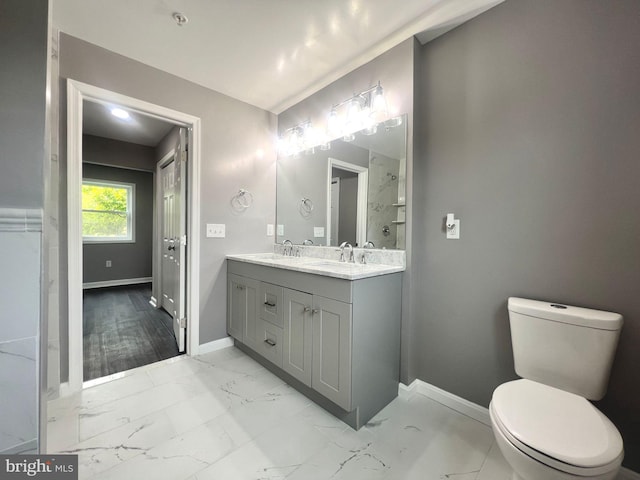 bathroom featuring tile patterned floors, vanity, and toilet