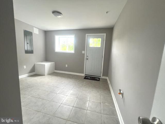 foyer entrance featuring light tile patterned flooring and electric panel