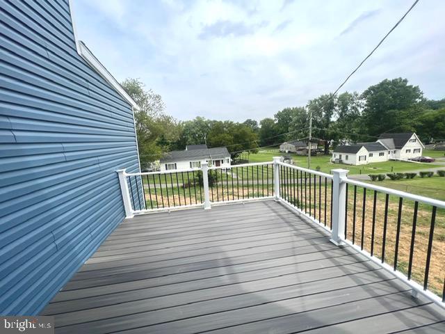 wooden terrace with a yard