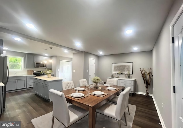 dining space with dark wood-type flooring