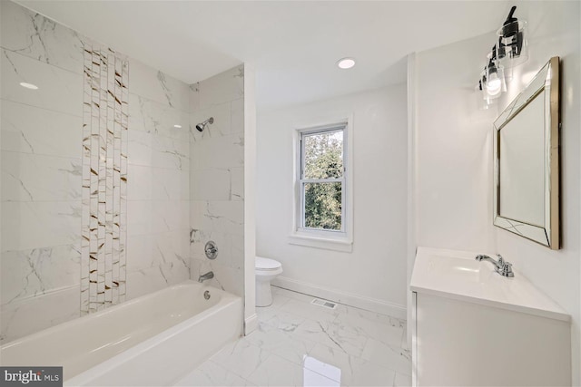 full bathroom with tiled shower / bath, vanity, and toilet