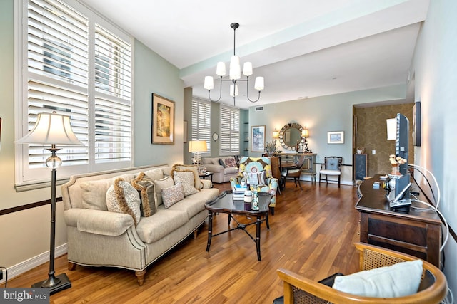 living room with an inviting chandelier and hardwood / wood-style floors