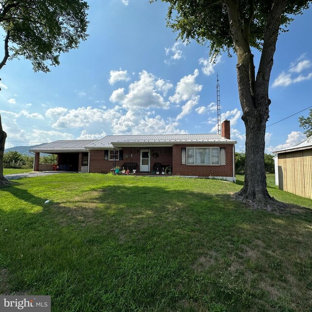 rear view of property featuring a yard