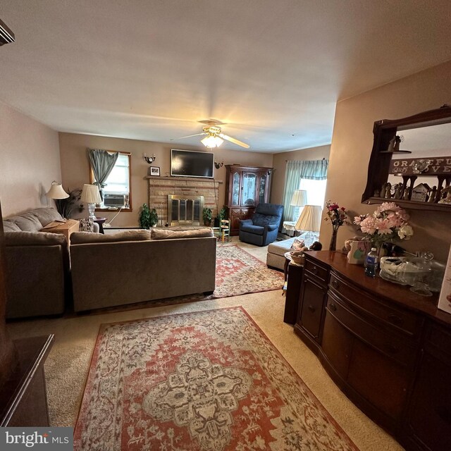 carpeted living room with ceiling fan, cooling unit, a brick fireplace, and plenty of natural light