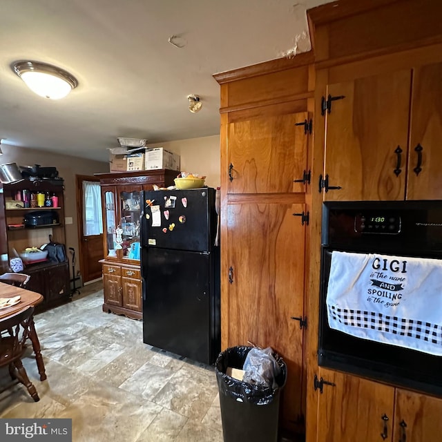 kitchen with black appliances and light tile patterned floors