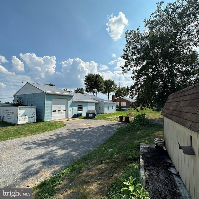 view of front facade with a garage and an outbuilding