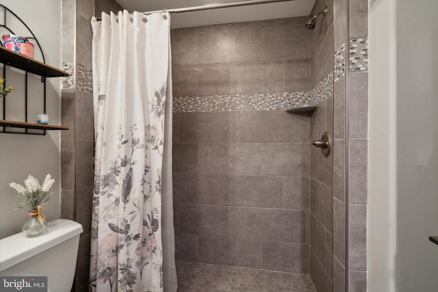 bathroom with walk in shower and toilet