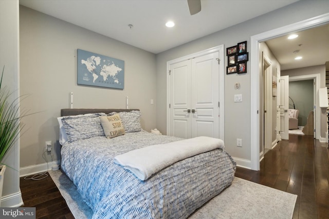 bedroom with ceiling fan, dark hardwood / wood-style floors, and a closet