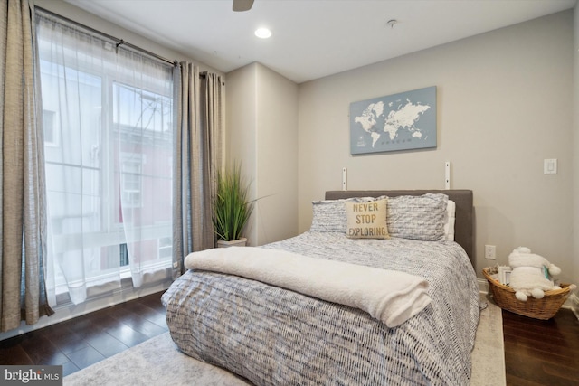 bedroom with ceiling fan and dark wood-type flooring