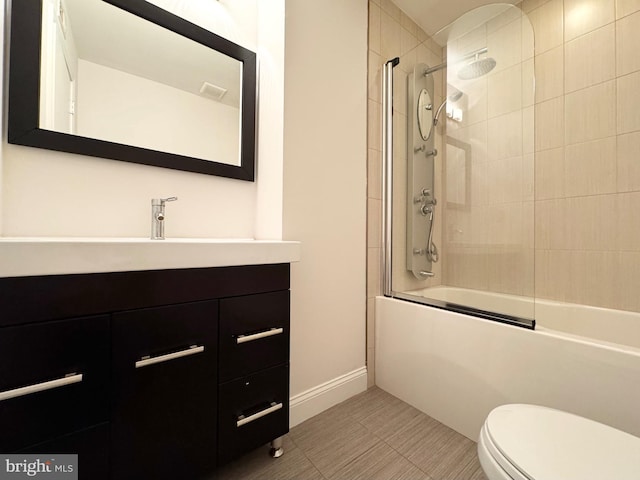 full bathroom featuring vanity, shower / bath combination with glass door, toilet, and tile patterned flooring