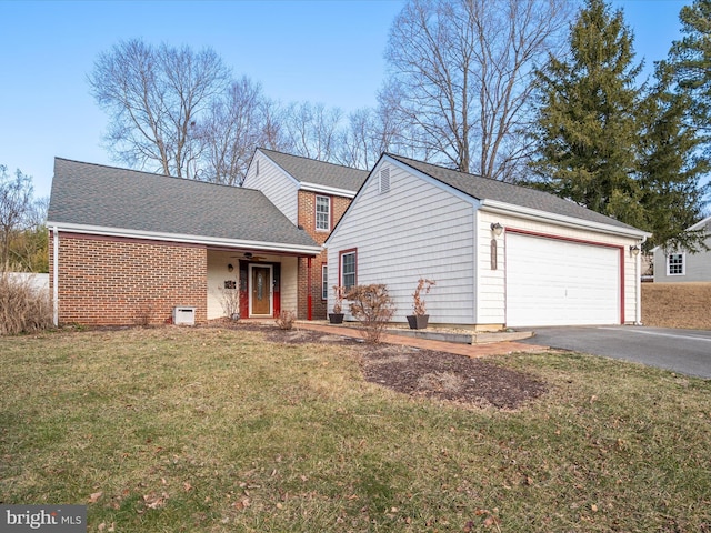 view of front of property with a garage and a front yard