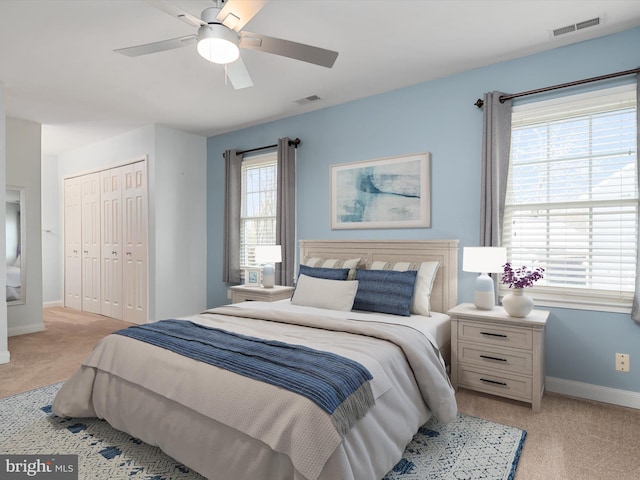 bedroom with light carpet and ceiling fan