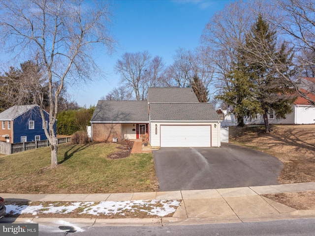 view of front of property featuring a garage and a front yard