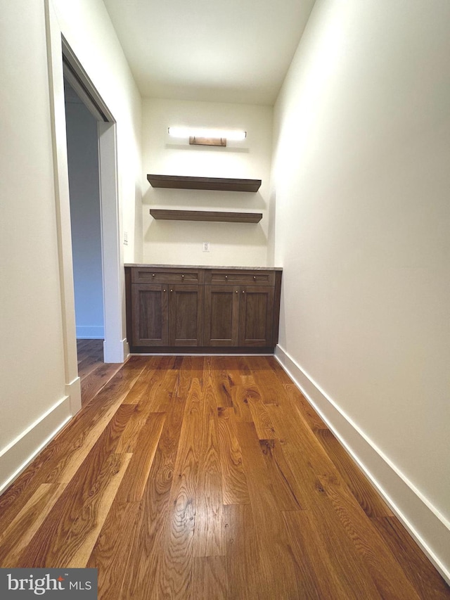 corridor featuring dark hardwood / wood-style floors